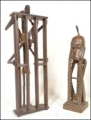 Two unusual 20th century carved African hardwood tribal upright CD rack stands. One in the form of a