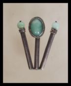 A stamped 925 silver pendant set with an oval jade cabochon flanked with two jade beads. Total