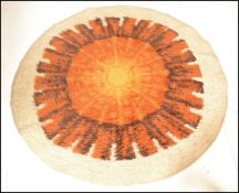A retro mid 20th century floor rug of circular form of wool construction having decorative design in