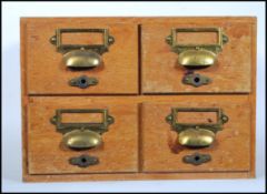 A retro mid 20th Century Industrial wooden 4 drawer table top filing cabinet index. Each drawer