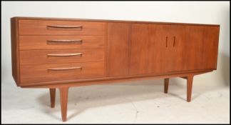 A retro mid  20th Century teak wood sideboard by G-Plan. The double doors with a bank of four
