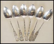 A set of six Chinese silver white metal teaspoons having leaf decorated bowls with bamboo stems.
