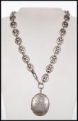 A silver hallmarked locket with bookchain necklace. The oval locket with Birmingham hallmarks set to
