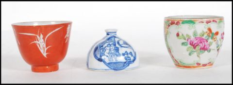 A 19th Century Chinese cup made in Hong Kong finished in red having white floral detailing and