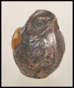 A silver hallmarked pin cushion in the form of a wren / bird with a fabric panel to the back.