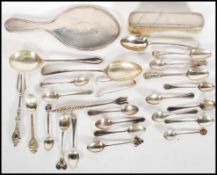 A collection of silver hallmarked flatware to include Georgian teaspoon, commemorative teaspoons,
