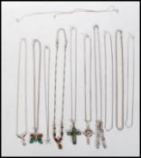 A group of stamped 925 silver pendant necklaces to include a celtic crucifix necklace set with a