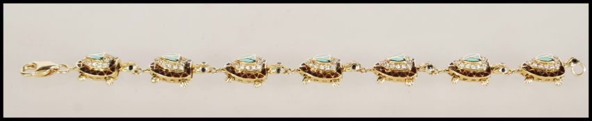 A 14ct gold figural bracelet. The bracelet having links designed in the form of turtles, decorated