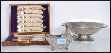 An Arts and Craft style Pewter fruit bowl, having makers mark stamped underneath for TUDRIC 01353