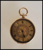 A stamped 18ct gold open faced pocket fob watch having a gilt dial with floral decoration and