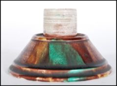 A 19th Century Victorian Majolica match striker of round form having brown and green mottled glaze