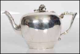 A 19th Century Victorian silver hallmarked teapot of squat circular form having rose finial to the