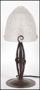 An early 20th Century Secessionist table lamp having hand worked metal base with frosted glass