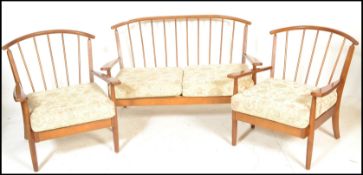 A vintage 20th Century open framed spindle back three piece suite in the manner of Ercol. consisting