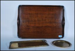 An early 20th Century Edwardian twin handled oak butlers tray set with a silver plated rim