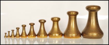 A set of ten 19th Century Avery graduating brass bell weights, the largest weighing 7lb all the
