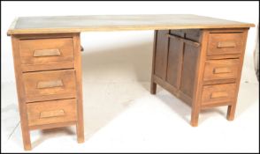 A early 20th Century 1920's Industrial Air Ministry style oak twin pedestal office desk having a