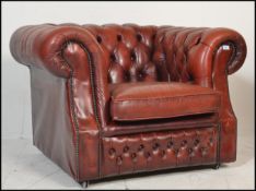 A 20th century Oxblood leather chesterfield armchair. The arm with button backing to the leather