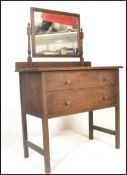 An early 20th Century country oak dressing table chest.  The twin drawers with knob handles with a