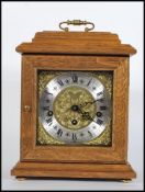 A 20th Century oak cased bracket clock, gilt engraved dial with silver chapter ring, Roman numerals,