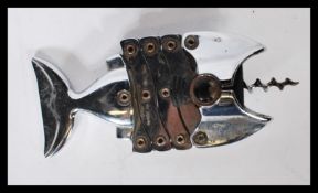 A retro chrome corkscrew / bottle opener in the fo