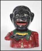 A vintage 20th Century cast iron money bank, being