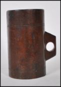 An unusual wooden tankard mug of cylindrical form