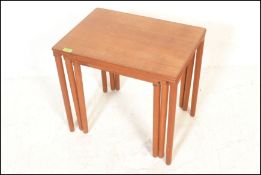 A retro 20th Century Danish teak wood nest of thre
