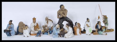A group of Chinese figures made of light brown cla