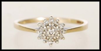 A hallmarked 9ct gold and diamond cluster ring. Ha