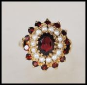 A 9ct gold English hallmarked ladies dress ring set with a central oval cut faceted stone with a