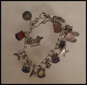 A vintage silver charm bracelet having a curb link chain with a heart padlock having fifteen