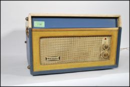 A vintage retro 20th Century two tone Dansette Bermuda four speed portable record player in blue and
