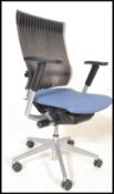 A contemporary Orangebox swivel desk chair having a blue upholstered seat with a reeded black