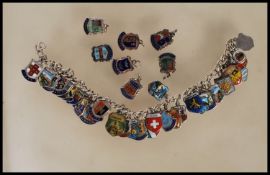 A vintage sterling silver souvenir / charm bracelet having a large number of silver enamelled