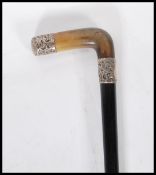 A 19th Century Victorian ebonised walking stick cane having a silver collar and end with engraved