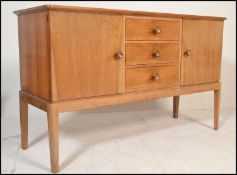 An original mid century Gordon Russell walnut sideboard / credenza. Raised on squared legs with a