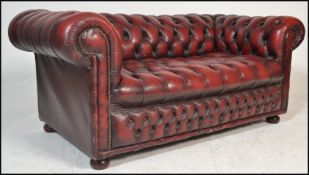 A good 20th Century Victorian style deep-buttoned back Chesterfield sofa with red leather /