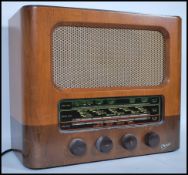 A vintage 20th century walnut cased Marconiphone radio having a glass panel to front with bakelite