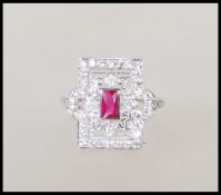 A sterling silver ladies Art Deco style dress ring of rectangular form having a central ruby with cz