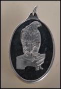 A fine 999 Suisse one ounce fine silver ingot pendant of oval form having an embossed eagle to