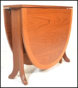 A 1970's 20th century Nathan teak wood drop leaf dining table. The full length drop leaves being
