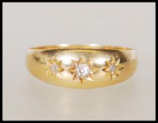 A hallmarked 18ct gold gypsy ring set with three round cut diamonds. Hallmarked Chester 1913. Weight