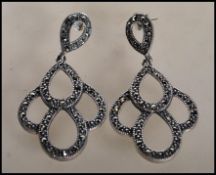 A pair of stamped 925 silver and marcasite drop earrings of teardrop form. Gross weight 11.9g.