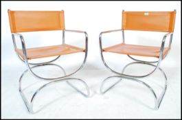 A pair or retro 20th Century chrome framed cantilever armchairs in the manner of Mart Stam, the seat