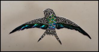 A stamped 925 silver and marcasite brooch pendant in the form of a swallow bird having enamel plique