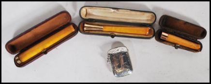 A group of three leather cased butterscotch amber bakelite cheroot holders dating from the early