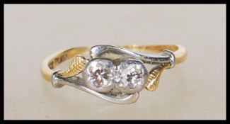 A stamped 18ct gold and platinum Art Deco 1930's diamond ring having two round cut diamonds in a
