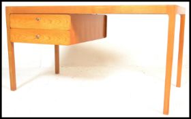 A retro 20th Century solid wood Scandinavian desk, set with two floating shelves to the left with