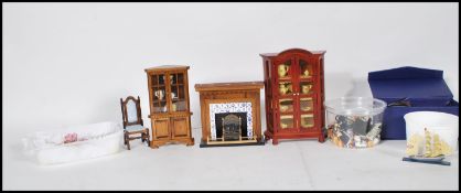 A good collection of assorted scale dolls house wares to include china cabinet, chair, fire place,